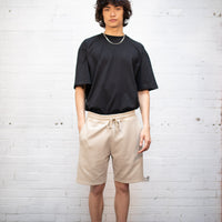 Plant dyed organic shorts in sand.