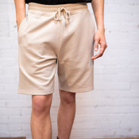 Plant dyed organic shorts in sand.