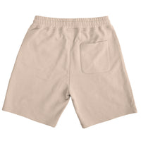 Plant dyed organic shorts in sand.